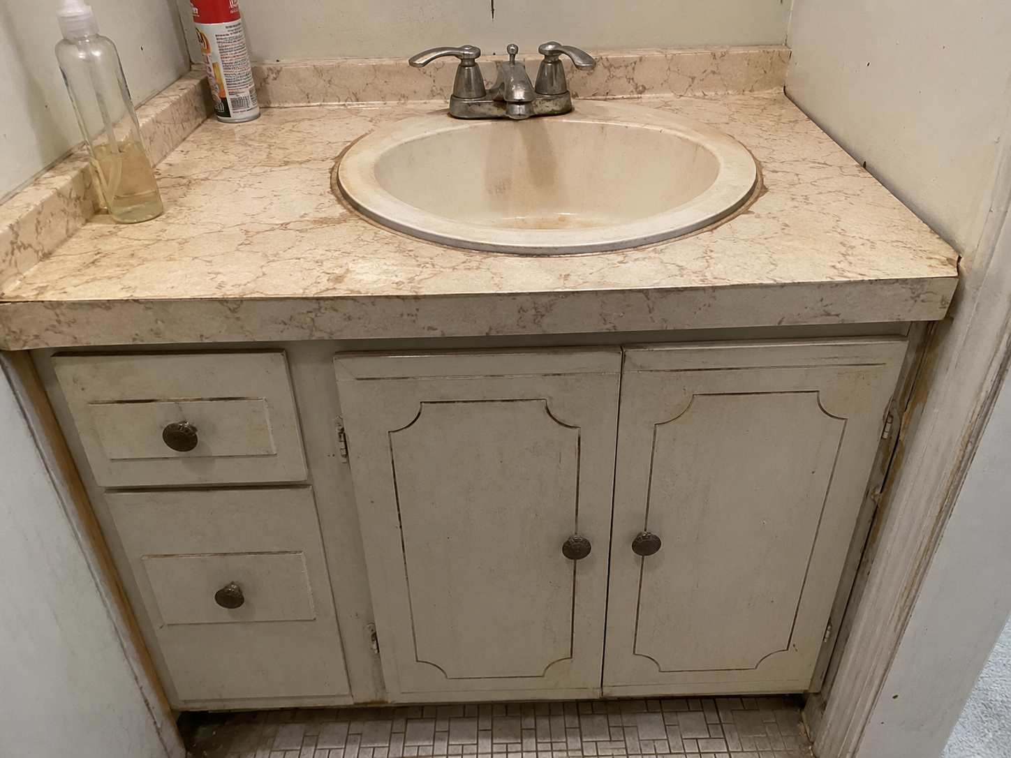 Outdated bathroom vanity before remodel